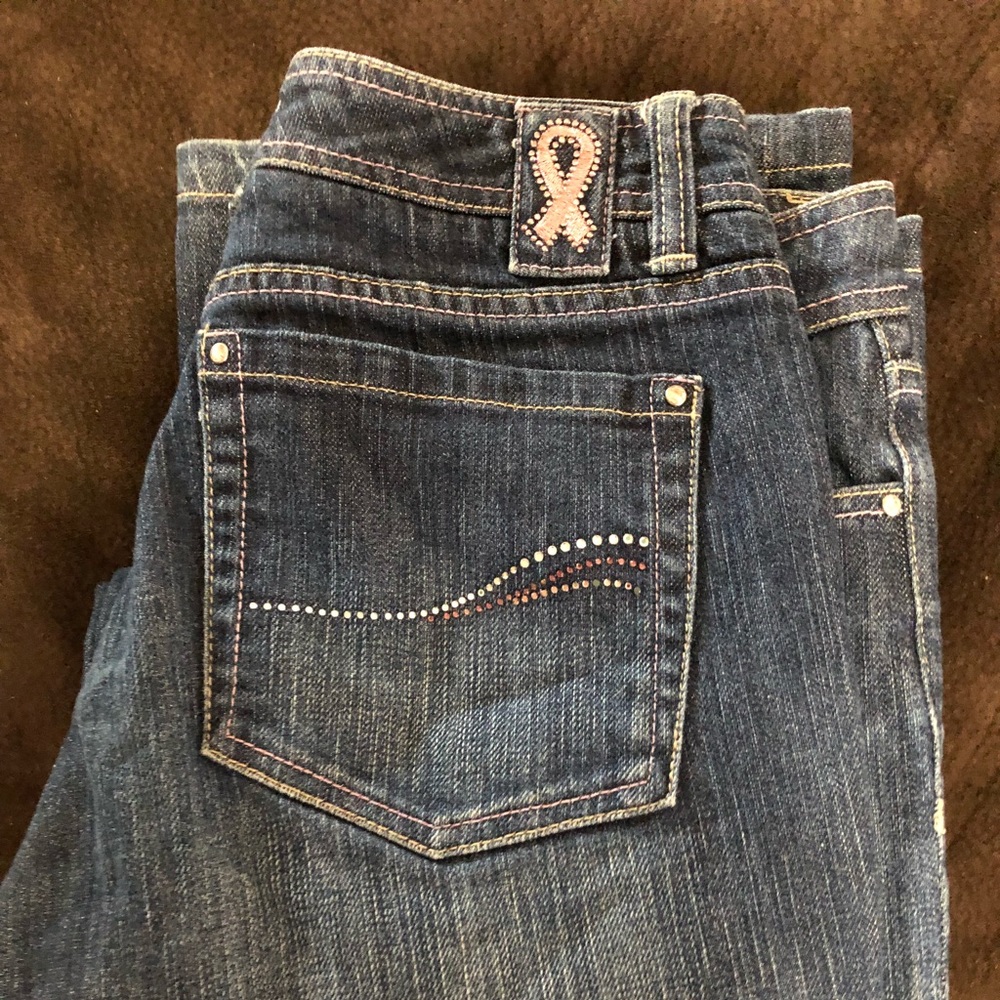 WHBM jeans honoring With Breast Cancer symbol.
